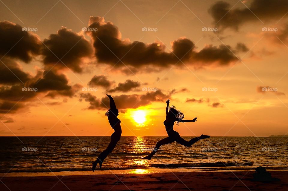Girls having fun on the beach. Girls having fun on the beach during sunset golden hour on tropical island in Thailand.