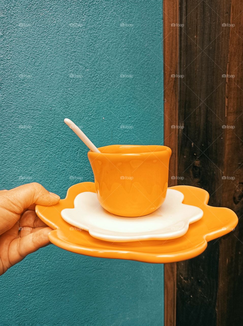 orange cup with blue wall