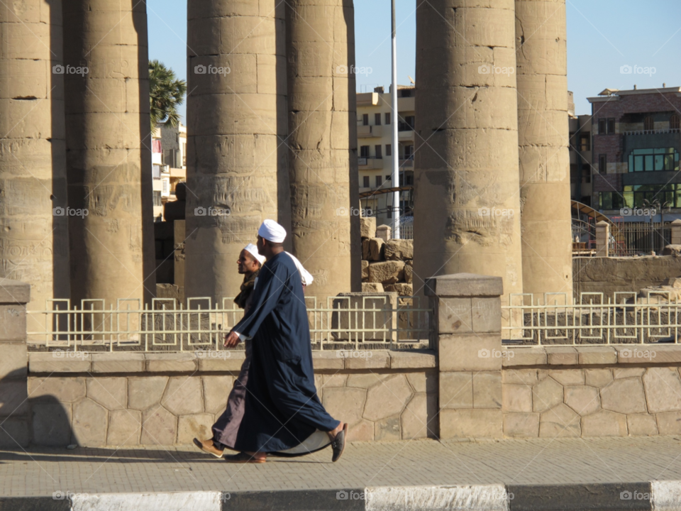 luxor egypt man walking column by shotmaker