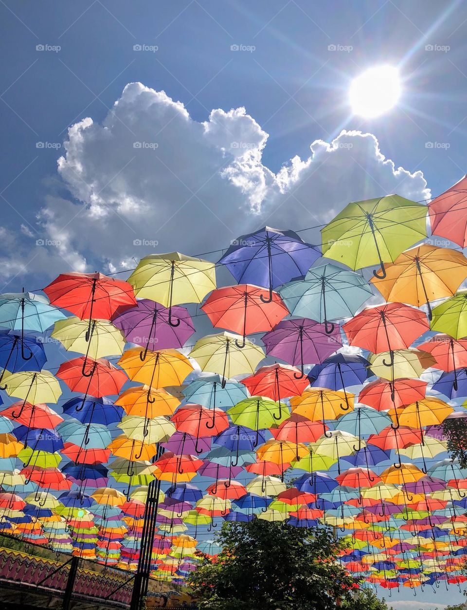 Funny summer installation with multicoloured umbrellas as protection from the bright hot sun