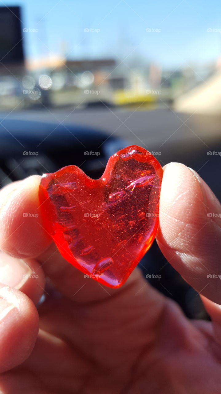 Close-up of a human hand holding red heart