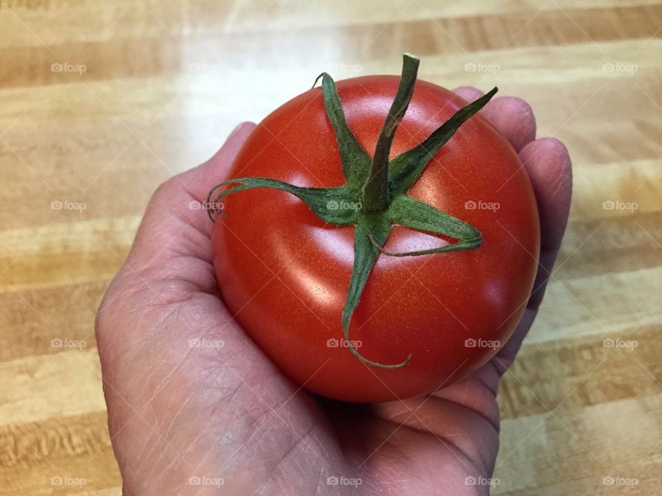 Holding a tomato