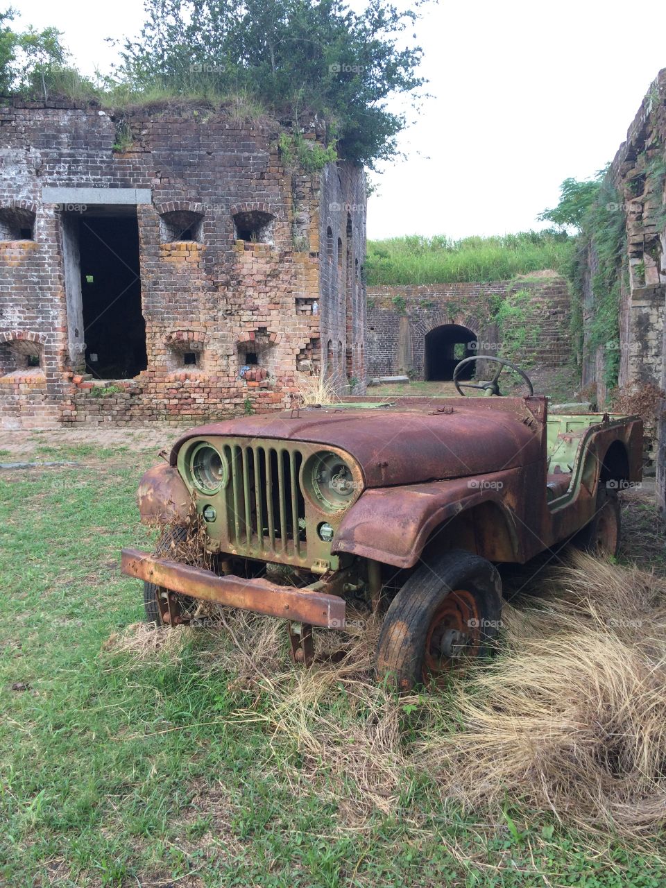 Antique rusty car in the middle of an old brick military fort in New Orleans, Louisiana. 