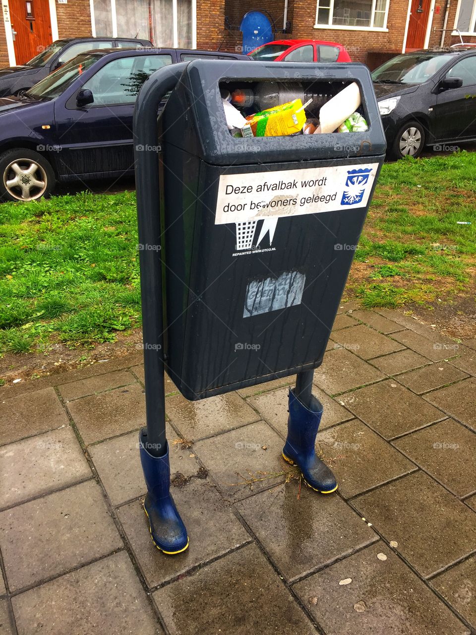 Public garbage bin wearing boots 