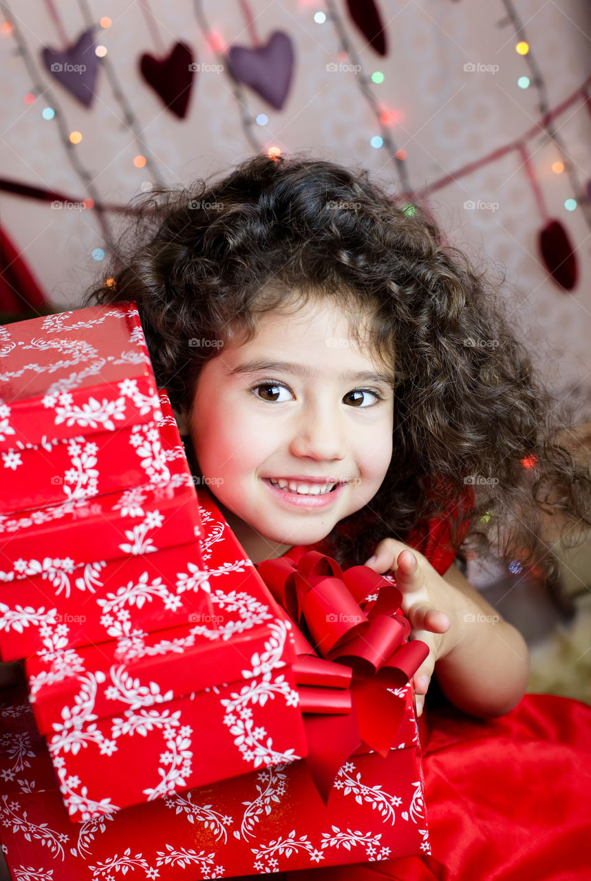 Smiling girl holding Christmas present