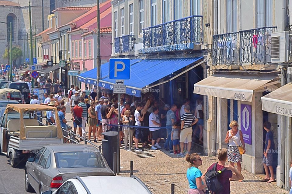 People queuing up to buy pastel de nata which is very famous and popular sweet pastry, around 10000 are sold everyday at this bakery in Lisbon Portugal 