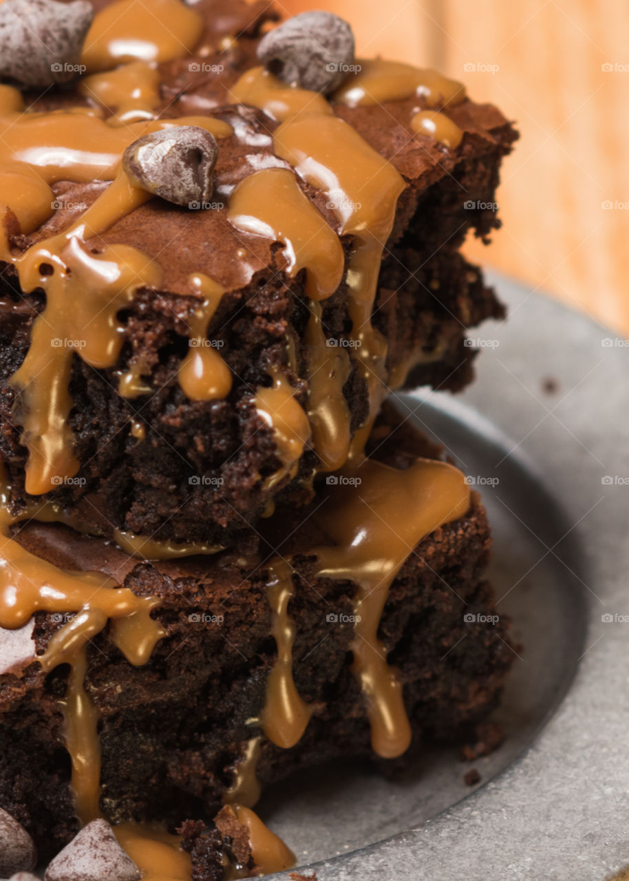 turtle style brownies baked and topped with caramel drizzle  and chocolate chips