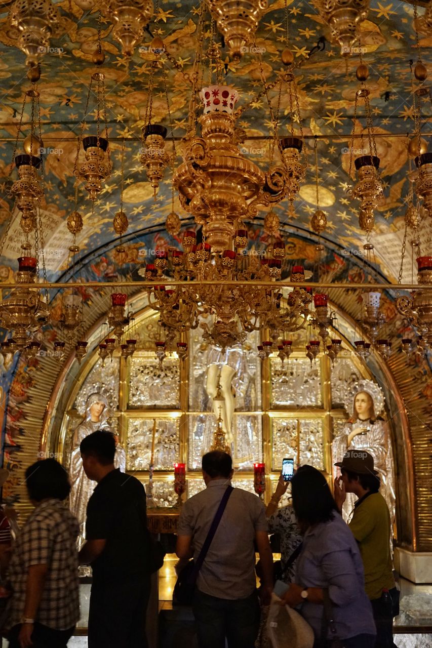people praying inside the church of holy sepulchre in jerusalem of Israel