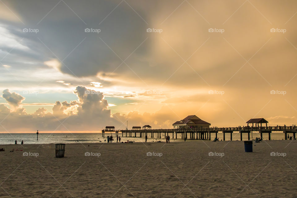 On the beach after the storm, the sun is painting the sky in beautiful colors 