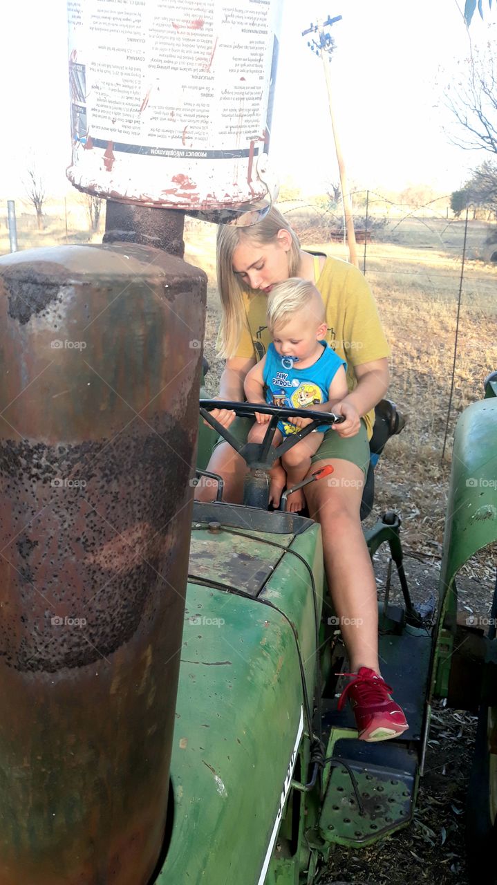 Brother and sister playing on tractor