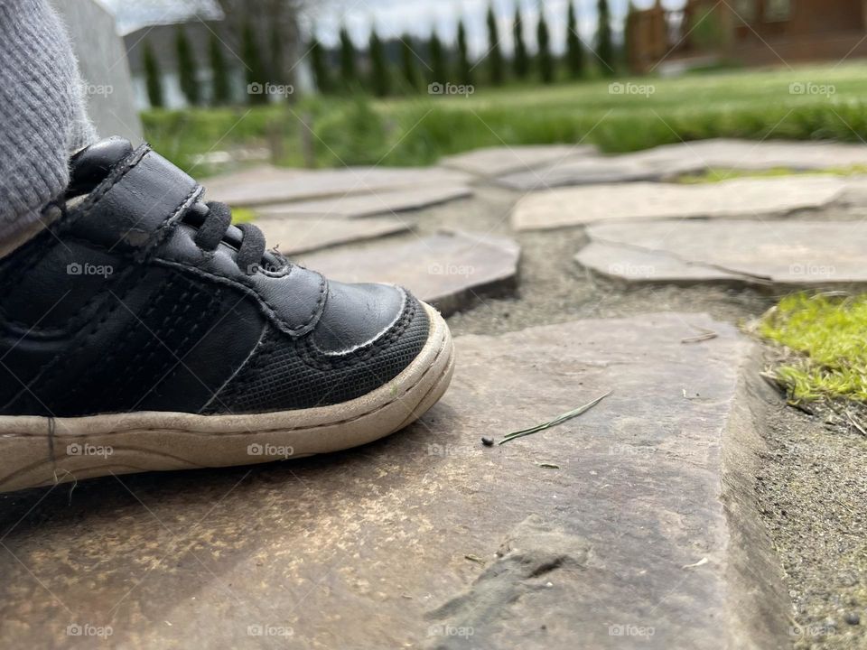 Toddler shoe on paving stones