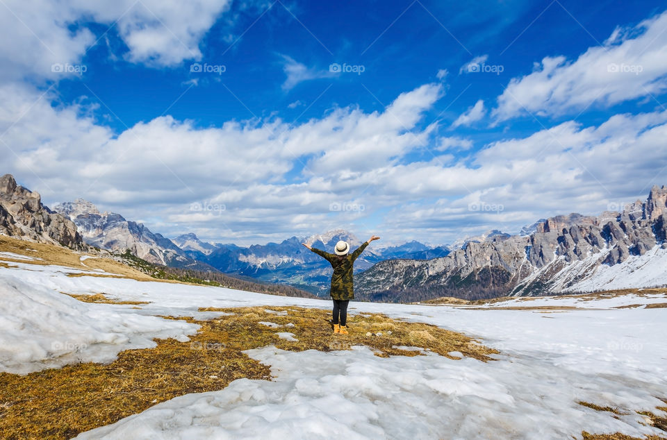 Scenic view of a person raising his arms in snowy weather