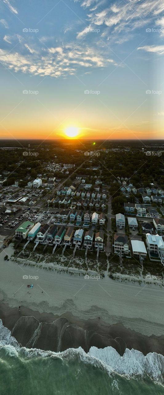 Flying my drone high above the beach as the sunsets on a gorgeous summer day 
