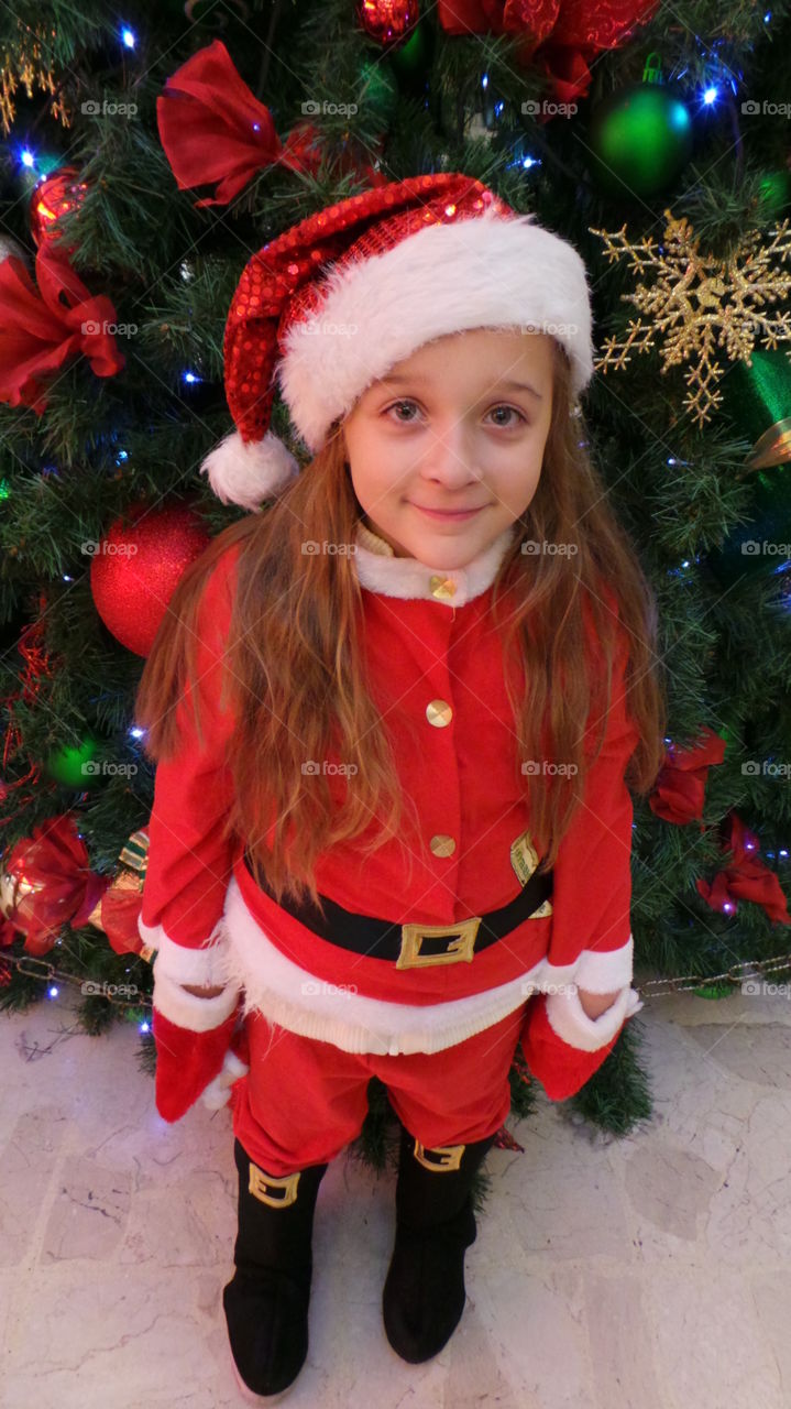 Father Christmas 
smiling child in a santa suit