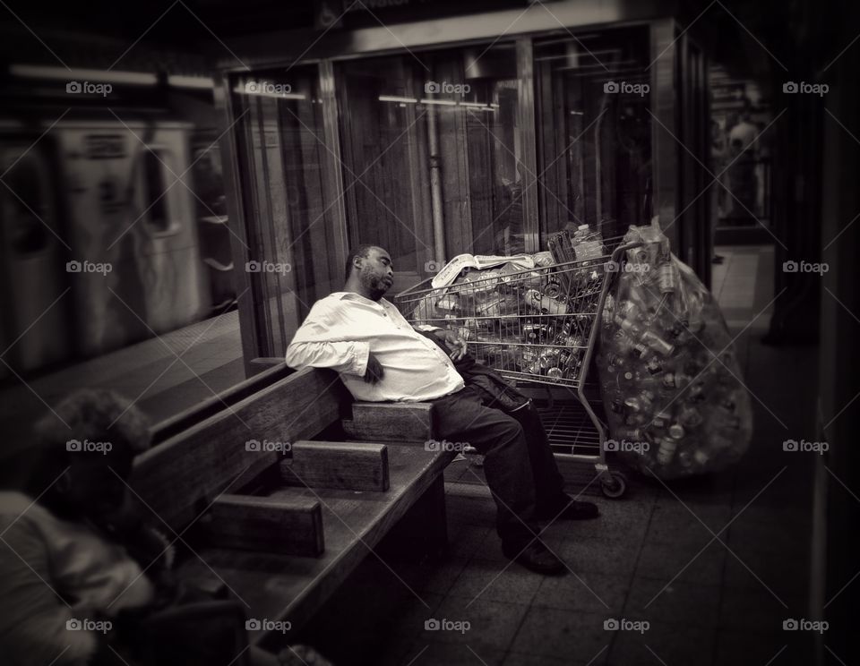 Homeless man collecting cans