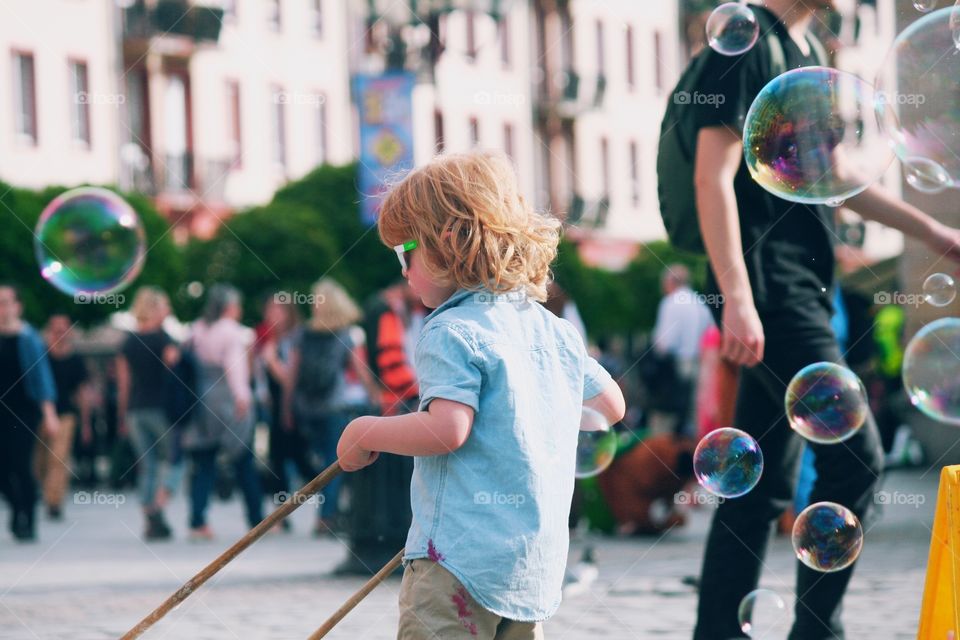 Little boy making soap bubbles like Pro!