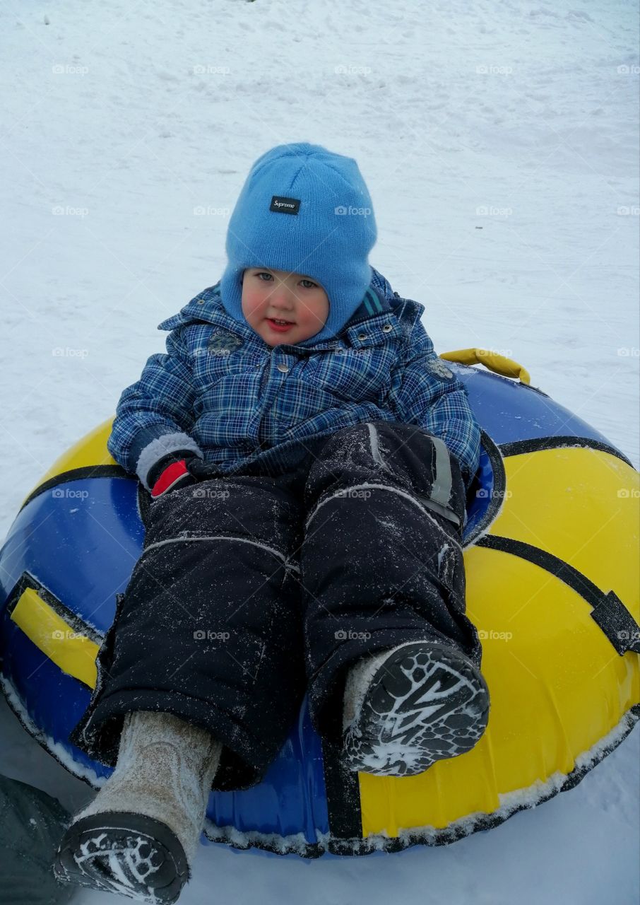 My youngest son is preparing to slide down a winter slide