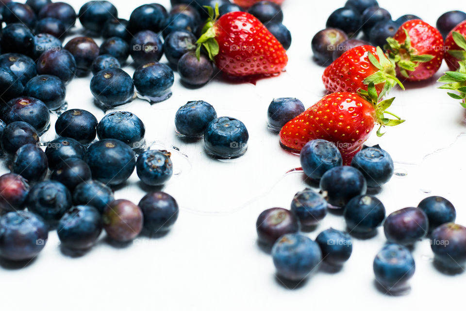 blueberries and strawberries on white background