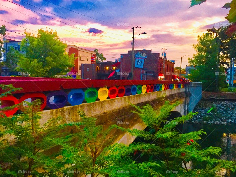Famous rainbow bridge painted with vibrant colors celebrating pride above the local canal in the heart of Broad Ripple Village in Indianapolis 
