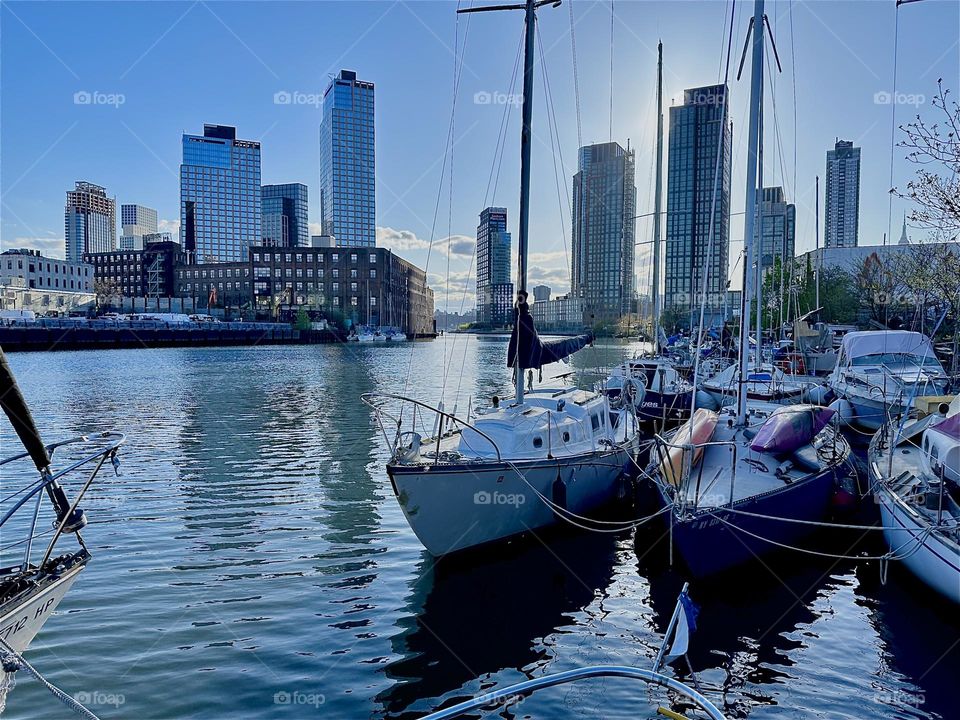 This is beautiful „Newtown Creek“ by the „Pulaski Bridge“ in LIC, Queens with its variety of pretty boats at twilight time when the „East River“ shimmers in shades of bright silver and blue. 2024. Hypnotic Productions