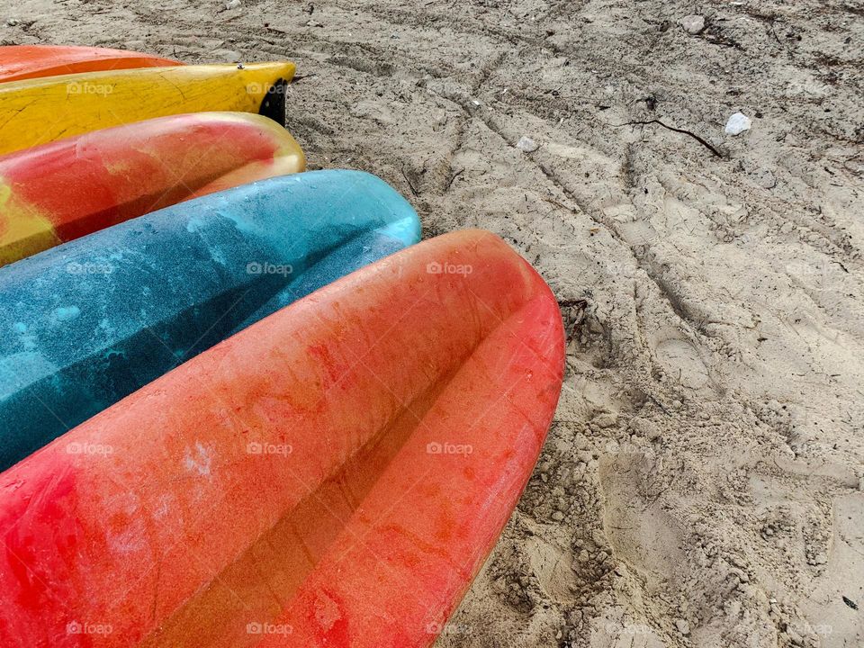 Colorful kayak lying on the beach 