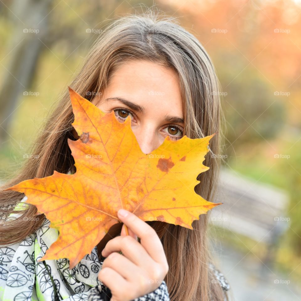 Woman with autumn leaf