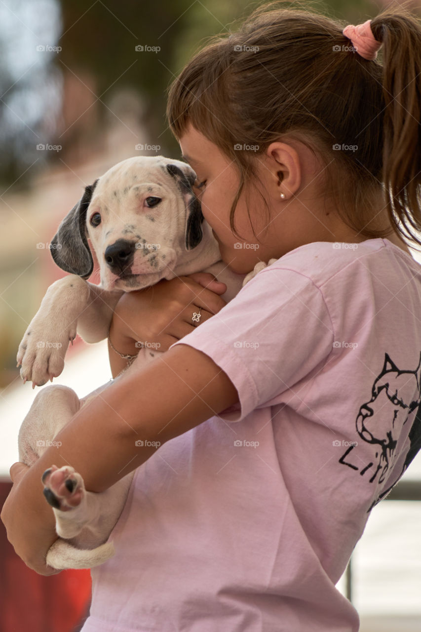 Girl kissing her dog