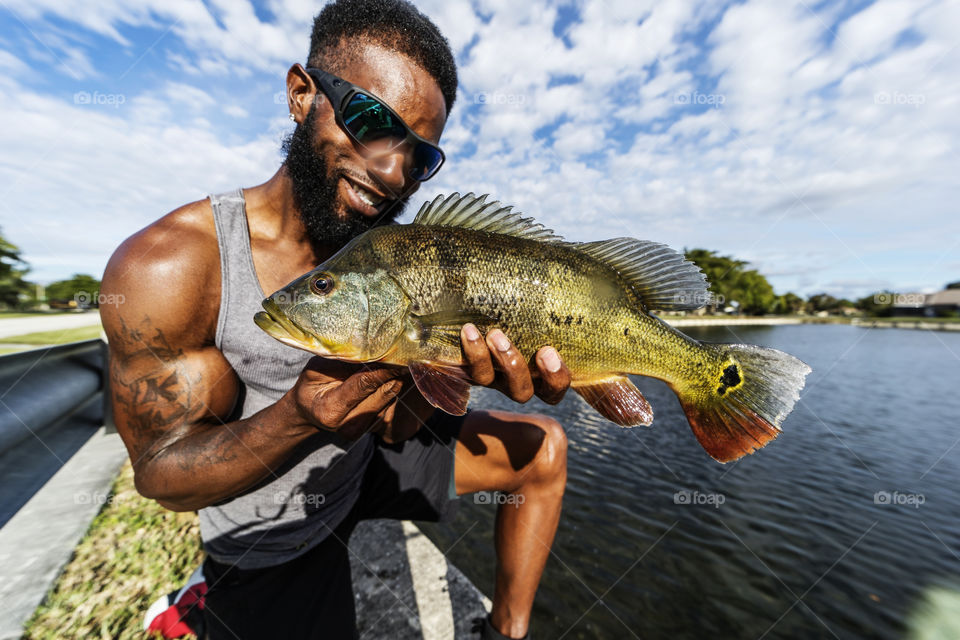 Holding a Peacock Bass