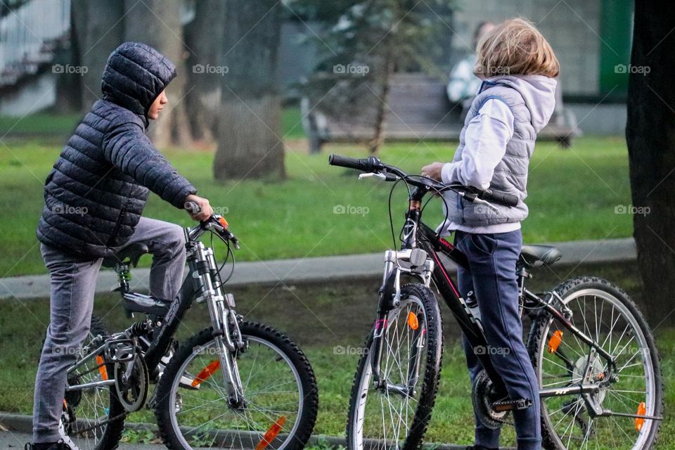 Boys riding a bicycles