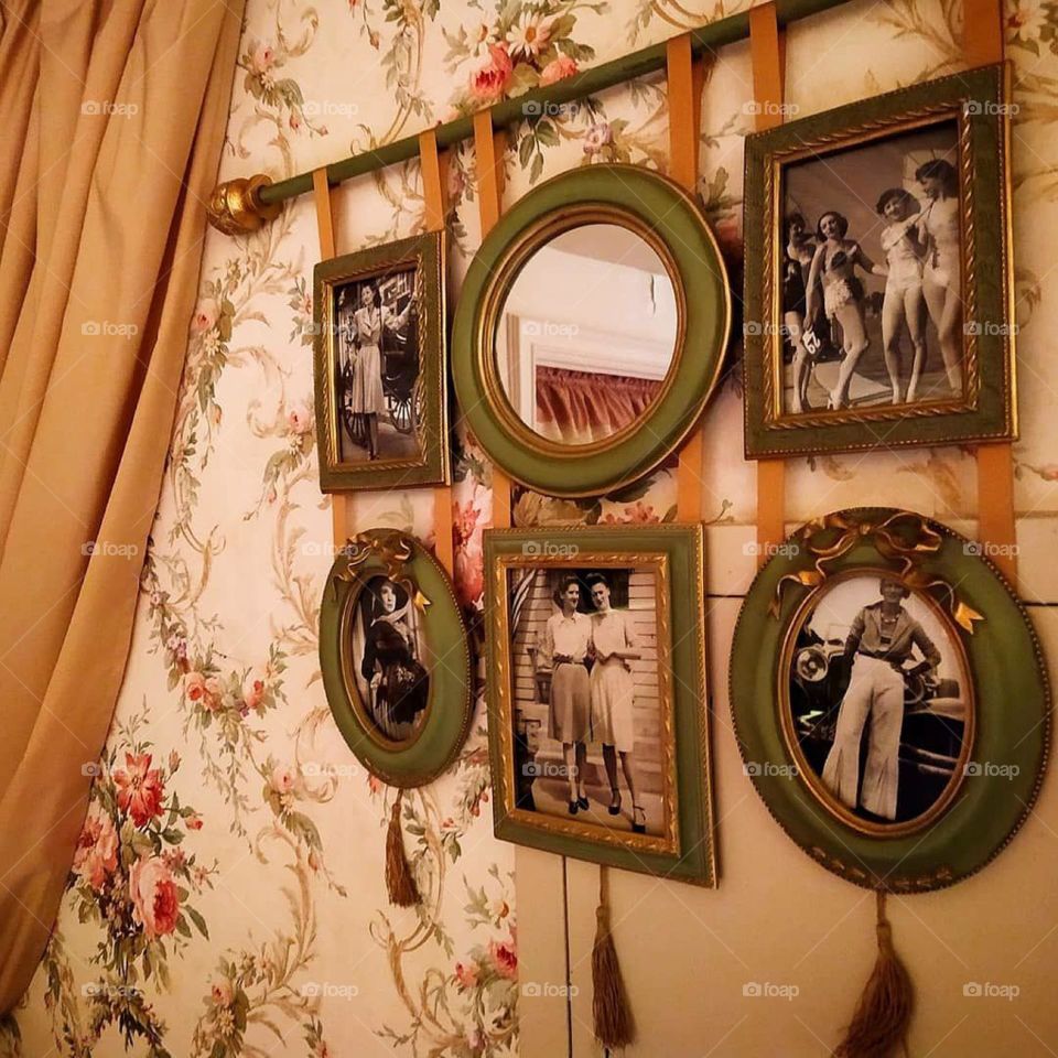 Wall with old family photos.Country style wallpaper