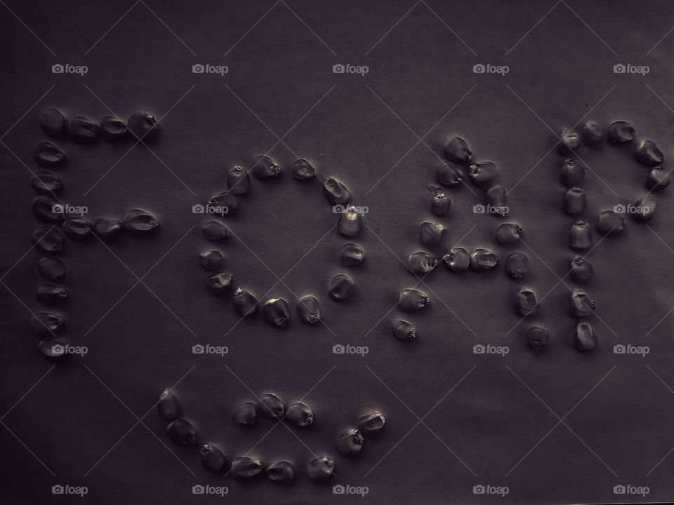 word "FOAP" art by corn seeds. art and illustration made by foap lover. smile face and foap in black colour.