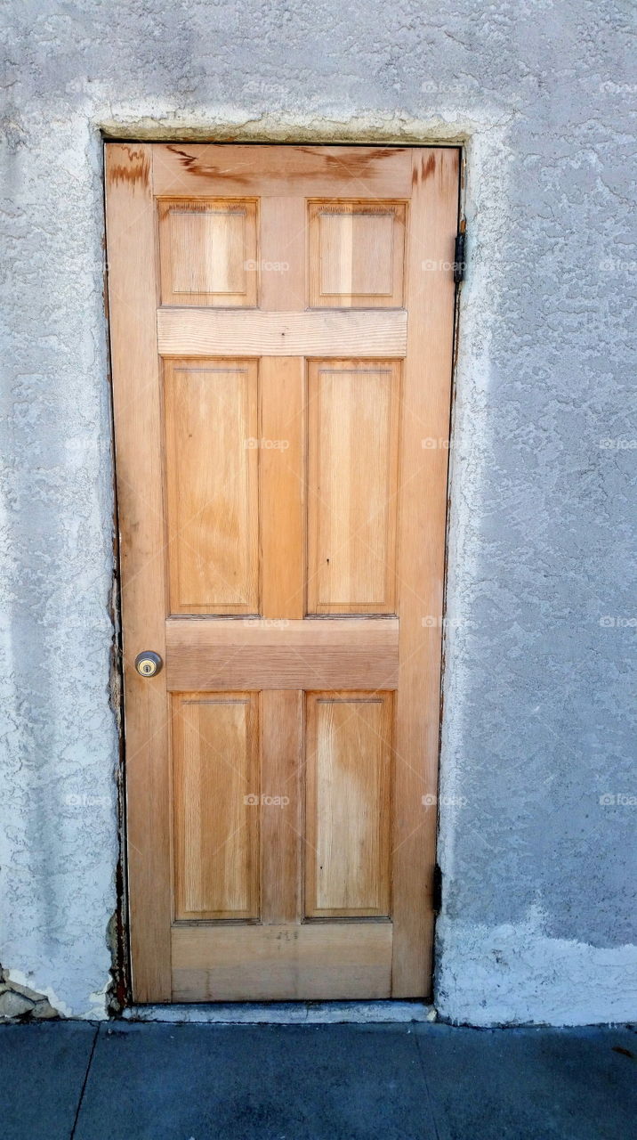 New wooden door surrounded by stucco