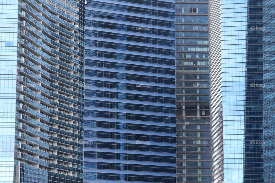 Walls of glass and steel among the skyscrapers of Singapore's financial district.