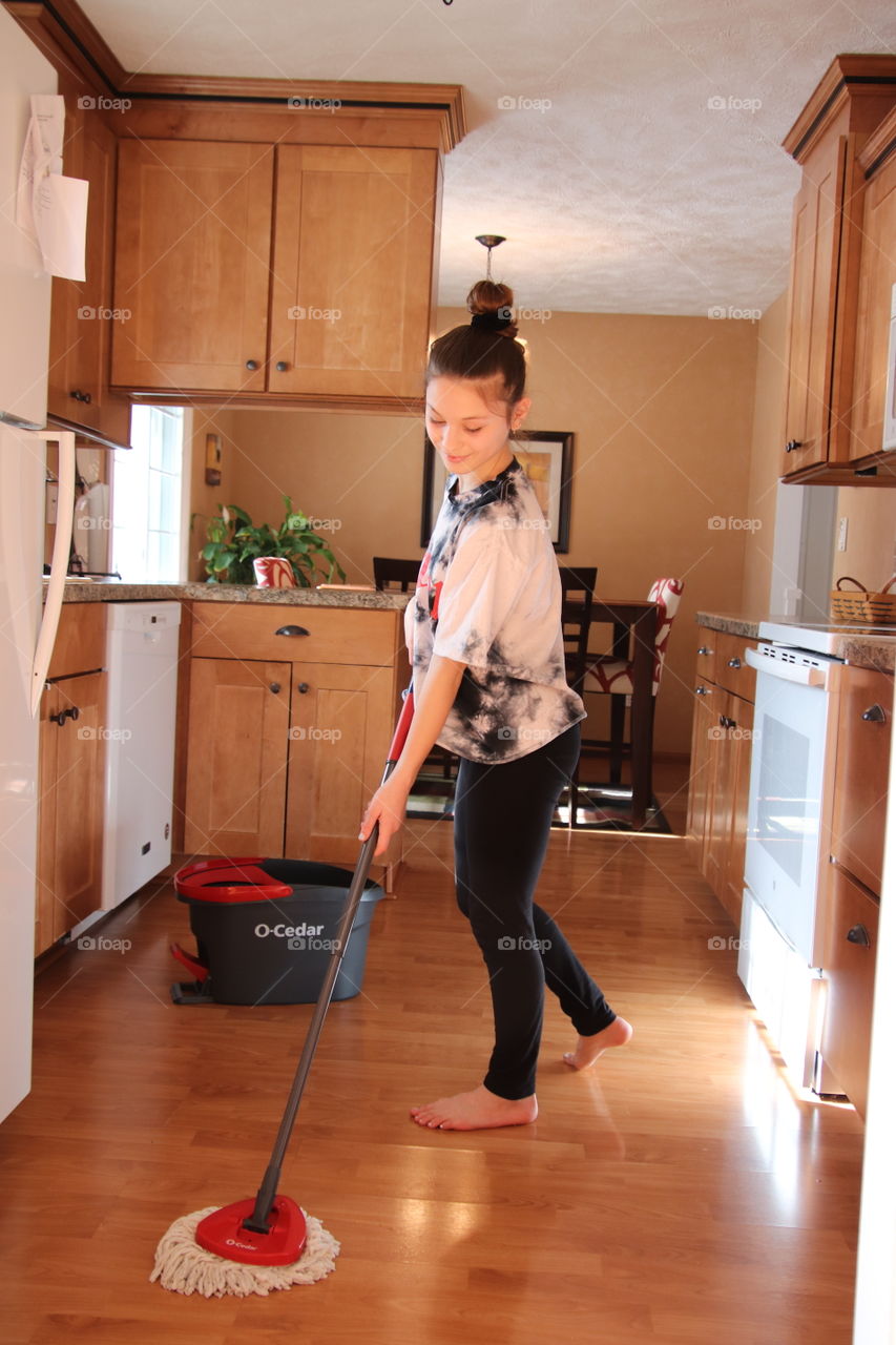 Girl using O-Cedar mop and bucket 