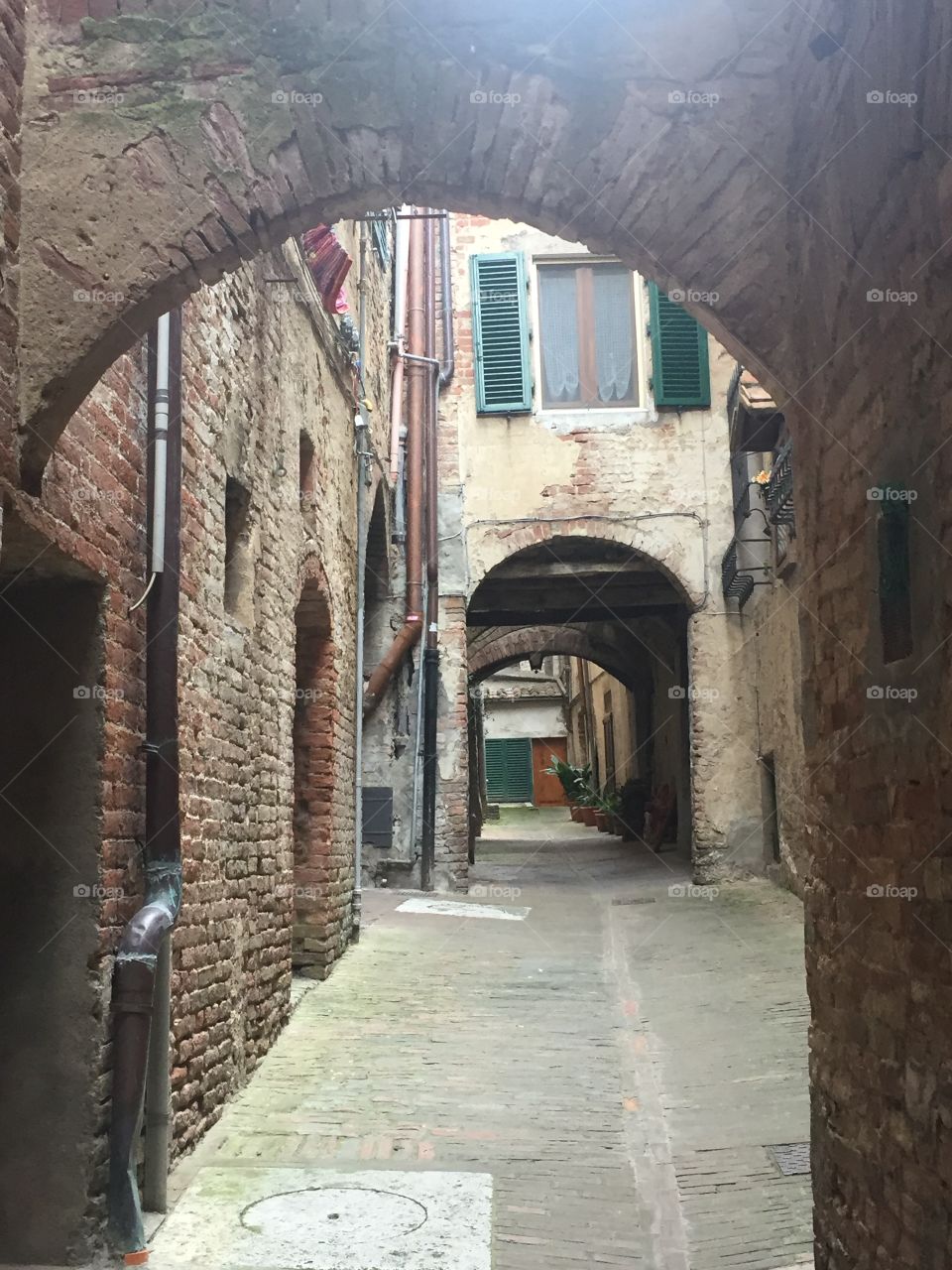 European medieval alley. Empty passage. Sienna, Italy. 