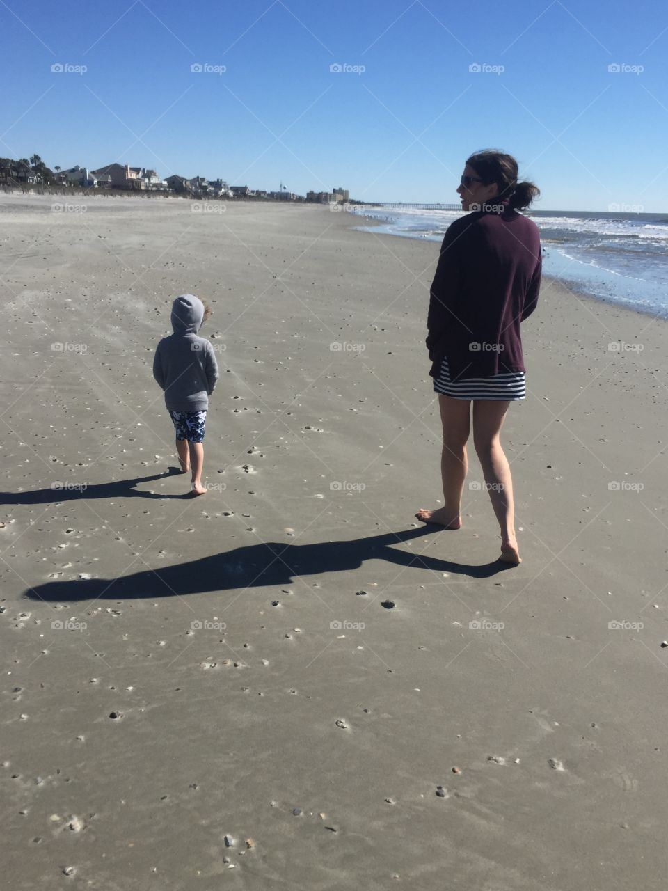 Mother and Son Walking on the Beach