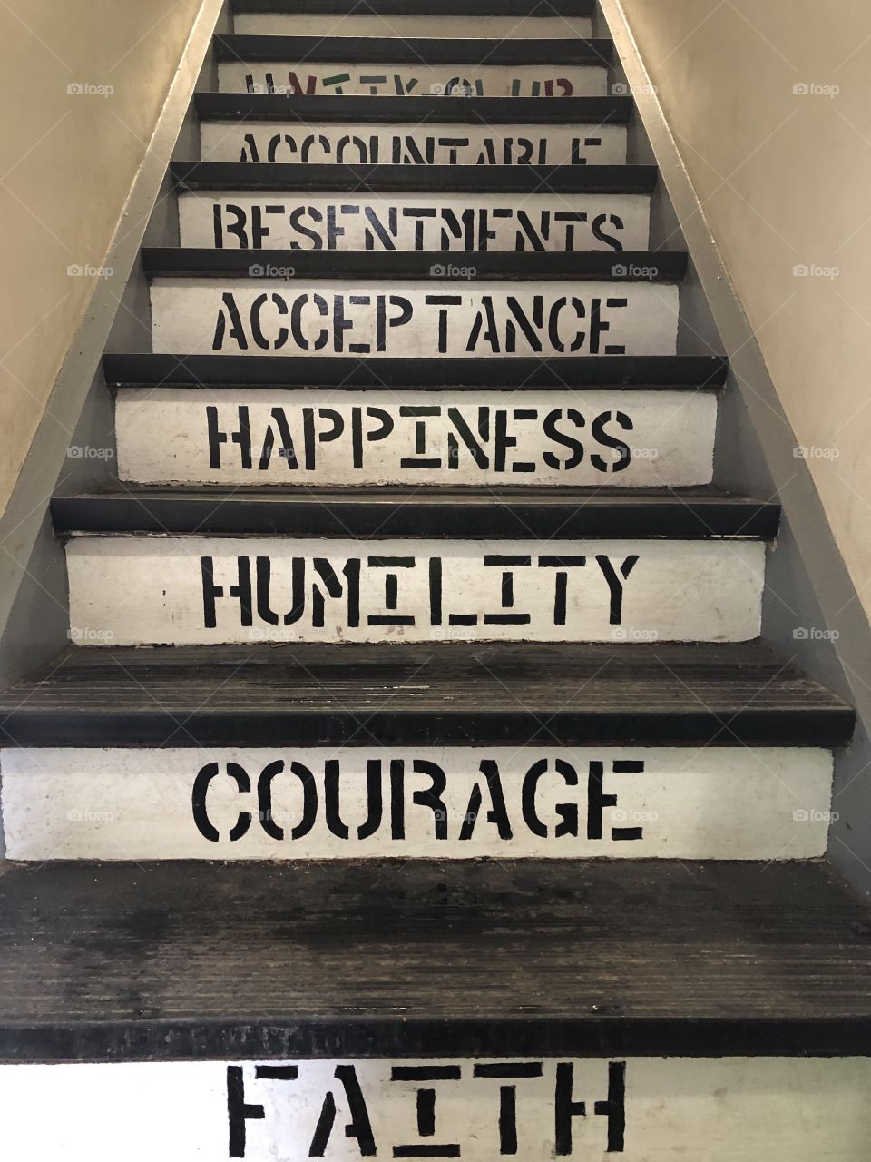 The stairs of Unity Club, a sanctum for addicts in the NoVa area, is inscribed with recovering addicts’ core values