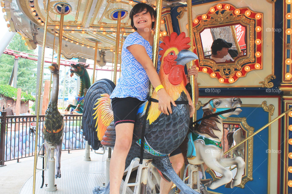 Summertime is for amusement parks! My daughter & my husband were riding this beautiful Carousel. The beautiful figures were all hand carved by a local company. My daughter rode the rooster & her dad reflected in the mirror rode a pretty pony. 🎠