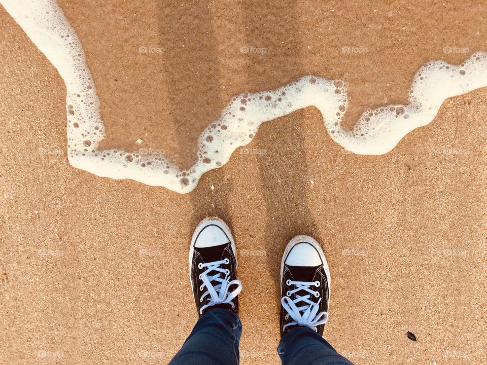 Beach waves catching converse