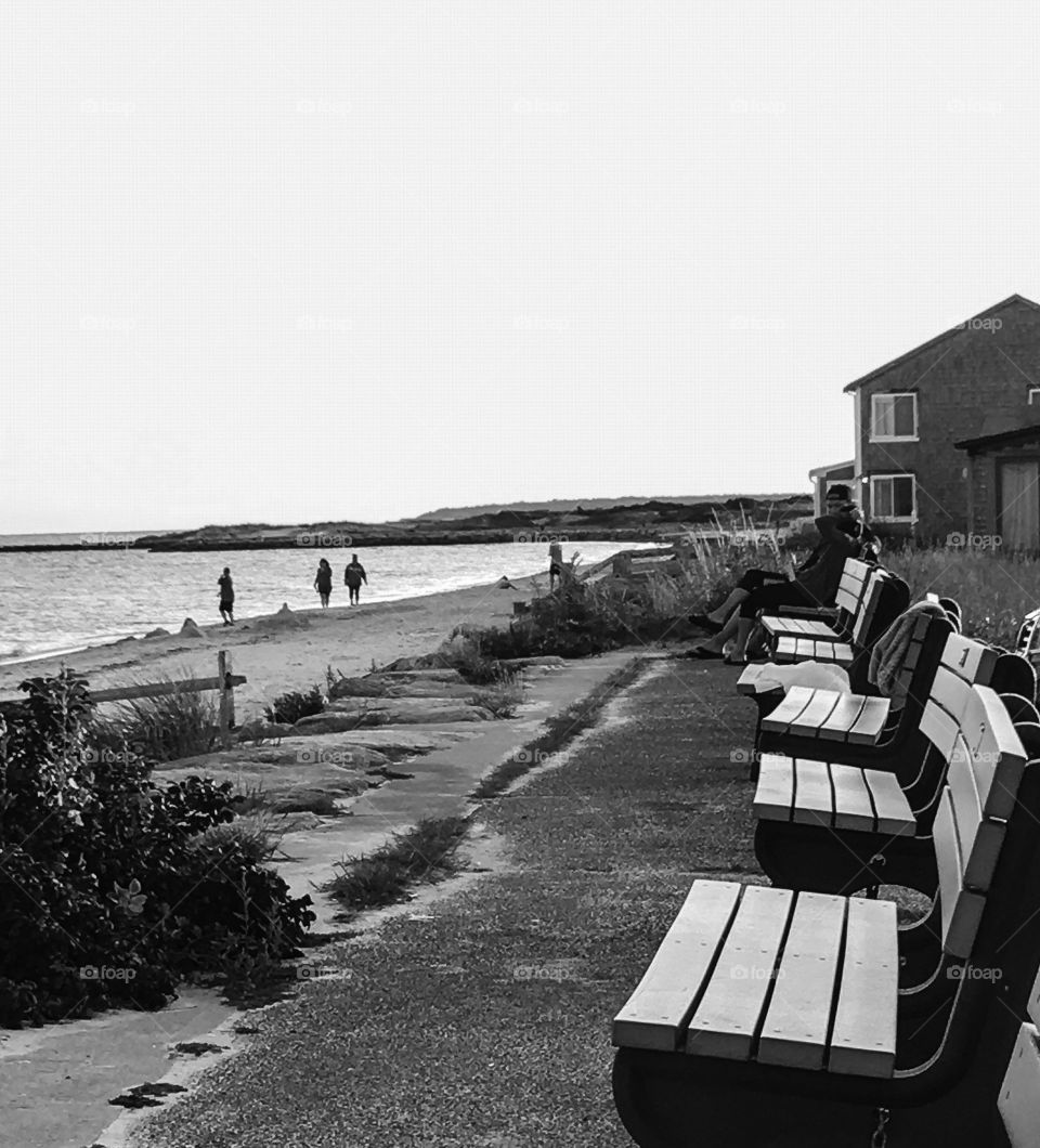 End of the day on the beach at Cape Cod.  A few people walking the beach, but otherwise a quiet scene. 