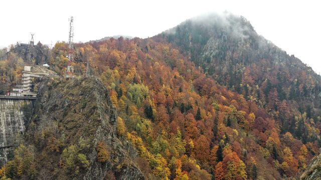 Fall at Vidraru Dam, Romania. Prometheus Statue.