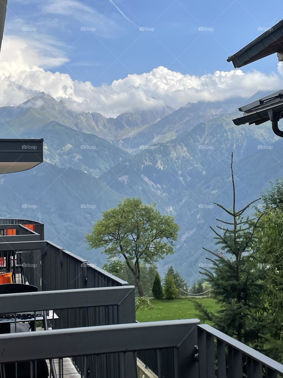 Stunning view of the Austrian Alps, as seen from the balcony of a hotel perched on a mountainside.