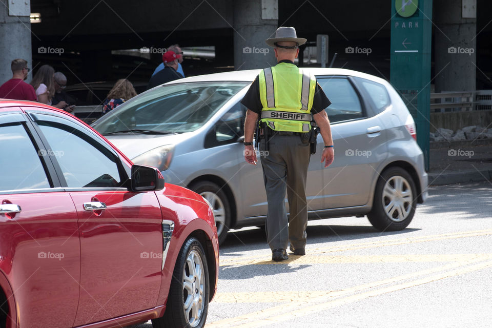 Police officer in an urban street directing traffic
