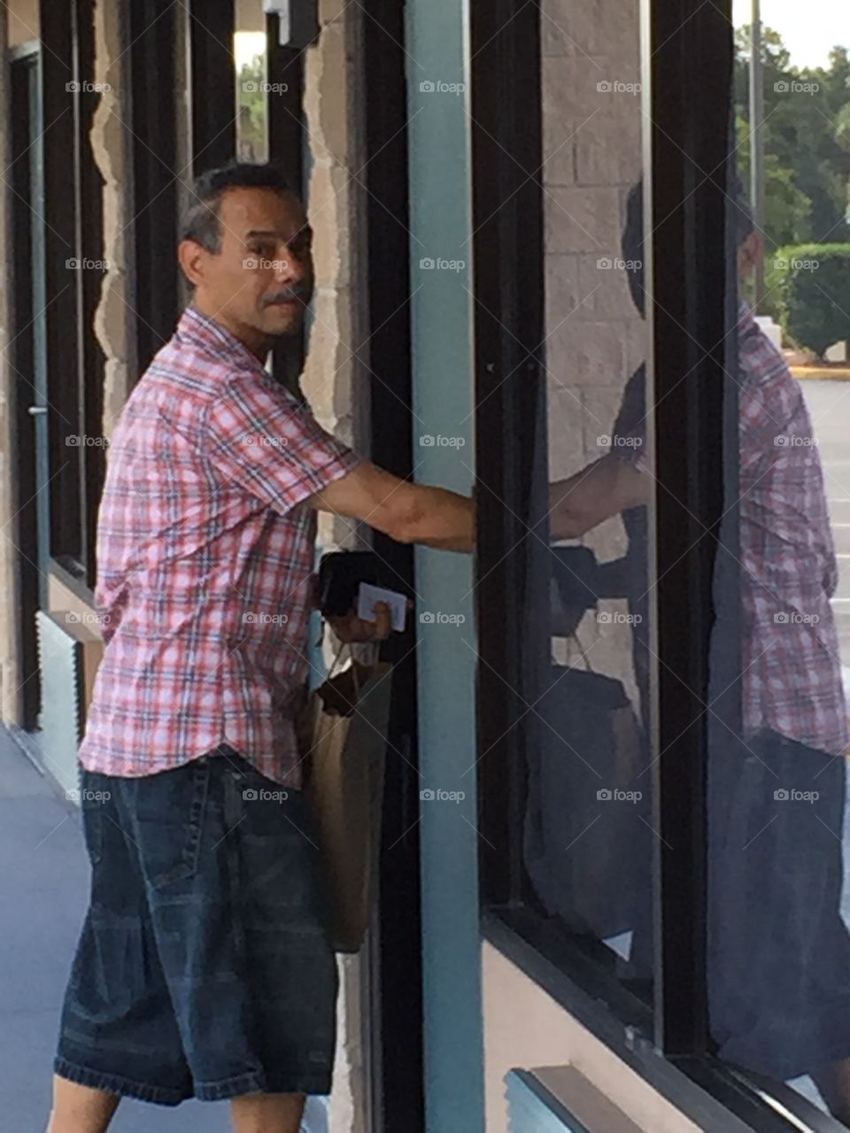 Entering The Days Inn. Deaf Hispanic Middle-Aged Man entering motel room in Davenport, Florida. August 2015.