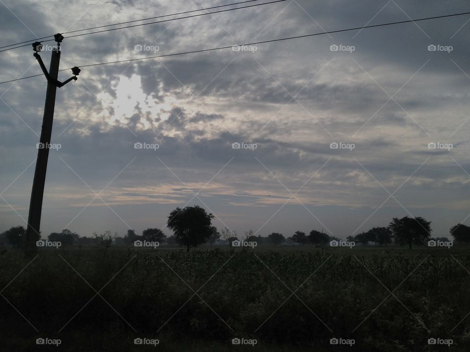 View of electricity pylon against dramatic sky