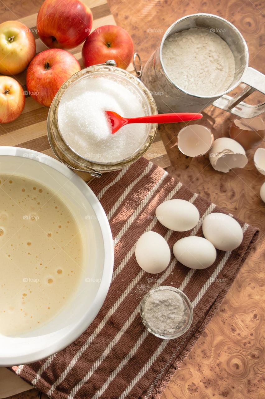 Making homemade puffed apple pie with eggs, sugar and flour.
