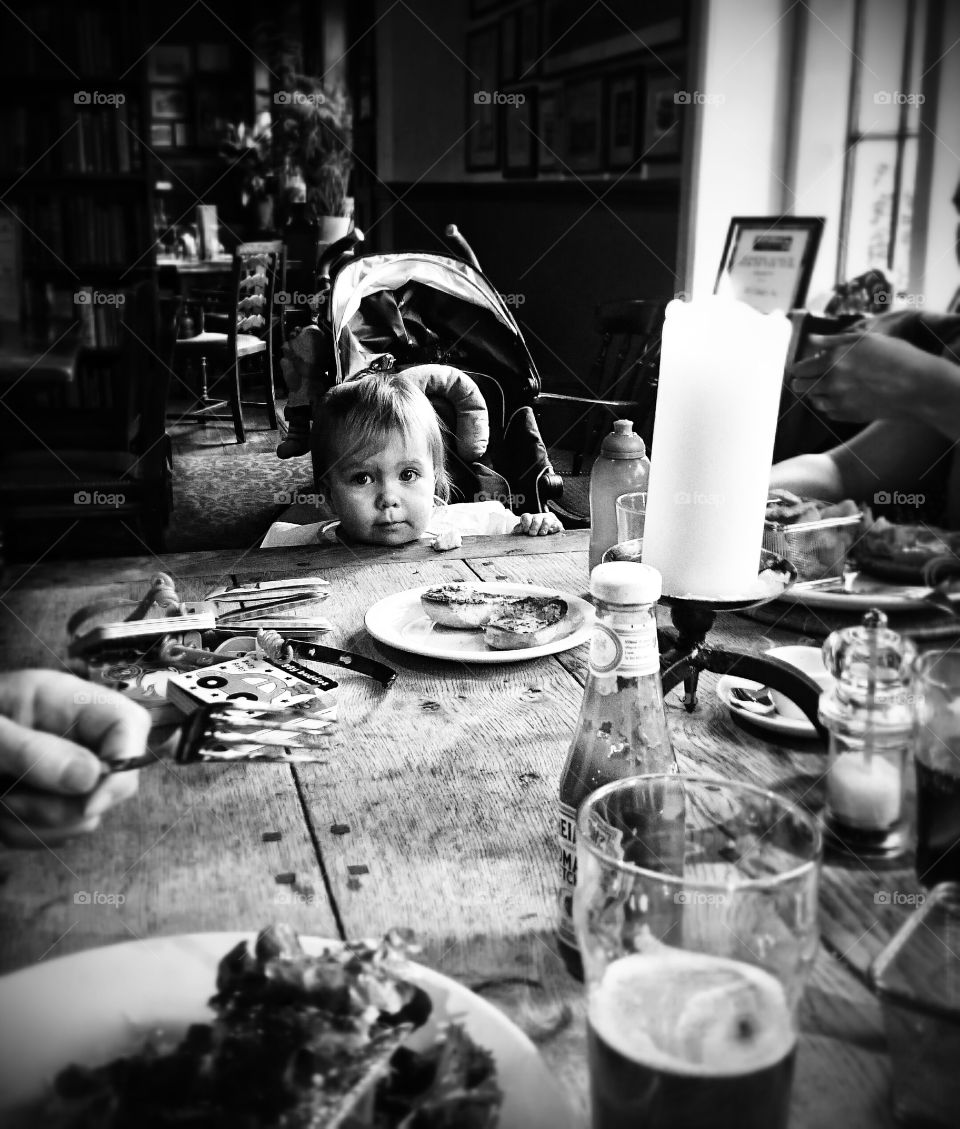 Little girl sitting in front of dinning table