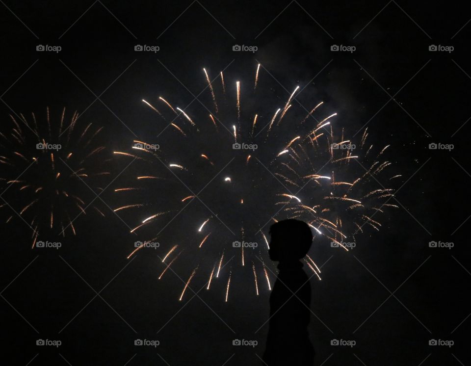 night silhouette in front of firework