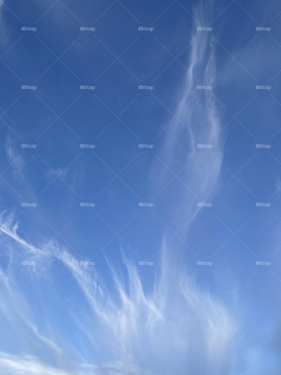 Bright white clouds with a bright blue and clear sky.