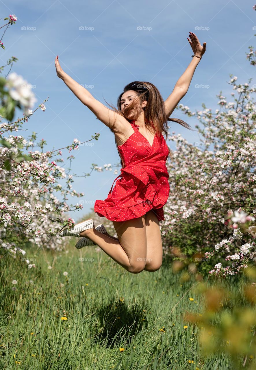 beautiful woman in spring blossom trees